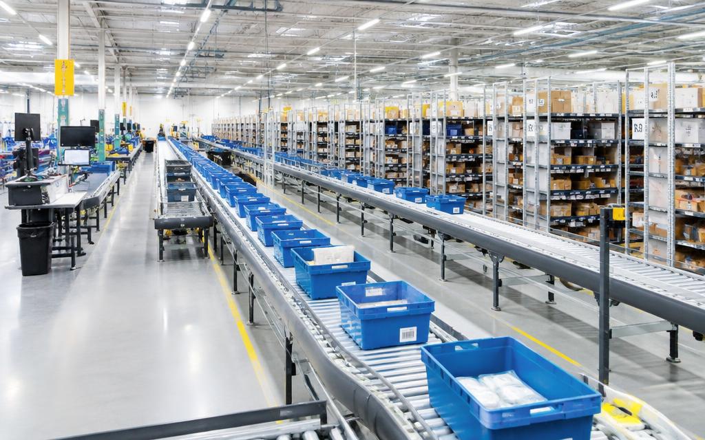 Fulfilment centre with totes on conveyors and rows of shelving